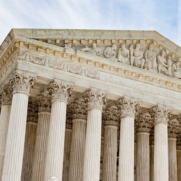 Front view of the United States Supreme Court building, showing its Corinthian columns and the engraving 